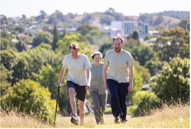 Support worker and participants walking outdoors together