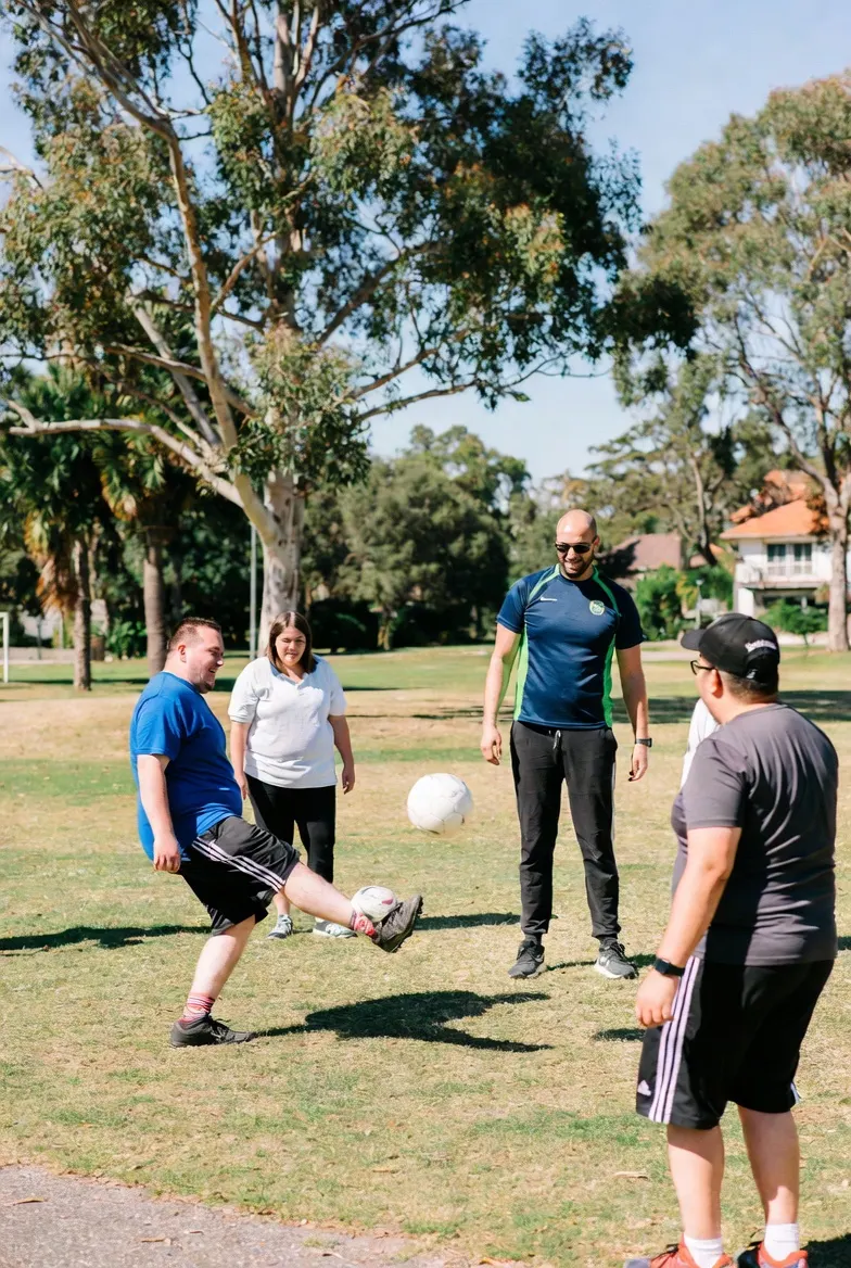 Group playing soccer in a park